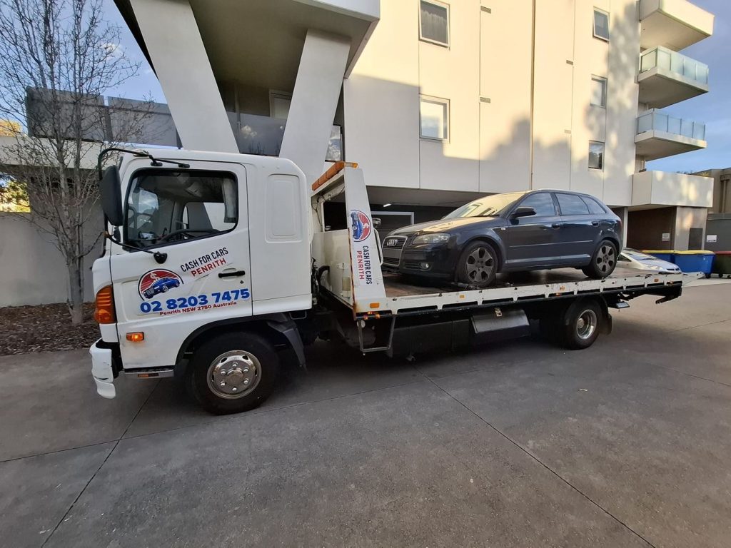 Black Audi A3 hatchback on the Cash For Cars Penrith tilt-tray truck