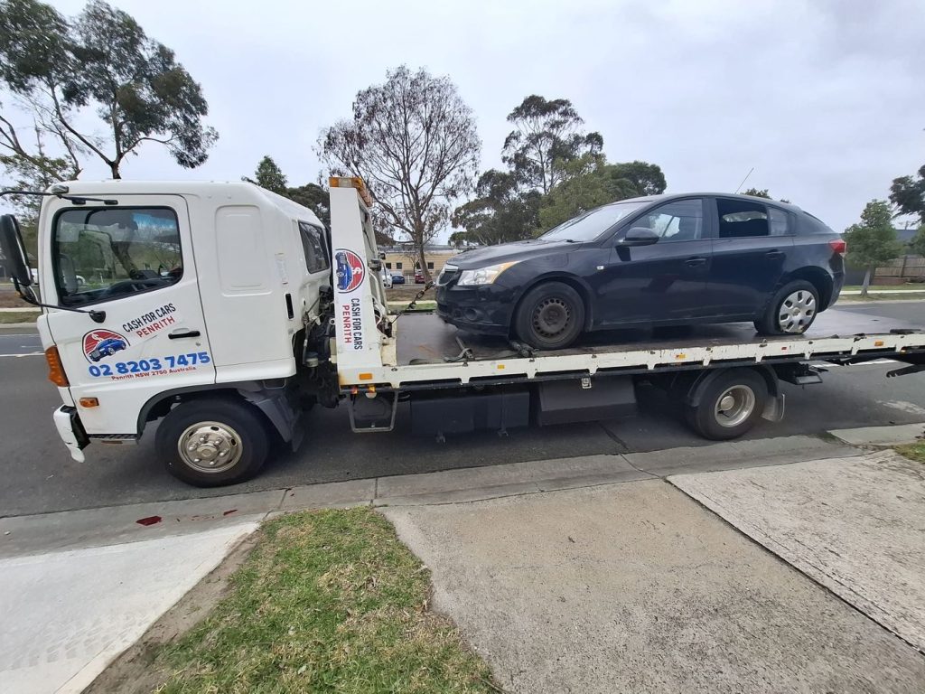 Black Holden Cruze hatchback on the Cash For Cars Penrith tilt-tray truck