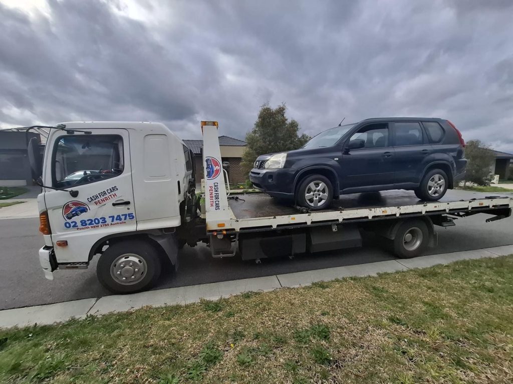 Dark Nissan X-Trail SUV on the Cash For Cars Penrith tilt-tray truck