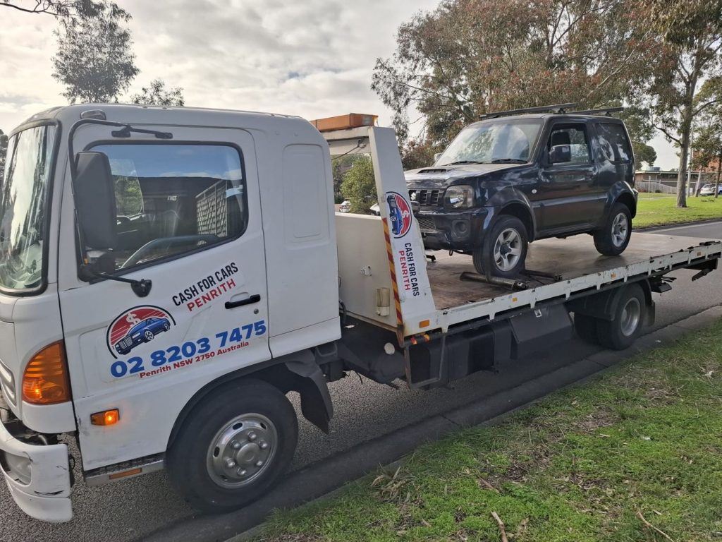 Black Suzuki Jimny 4WD on the Cash For Cars Penrith tilt-tray truck