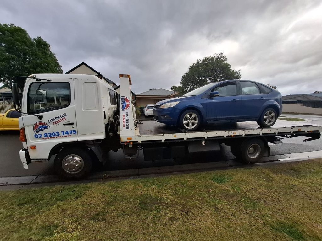 Blue Ford Focus hatchback on the Cash For Cars Penrith tilt-tray truck