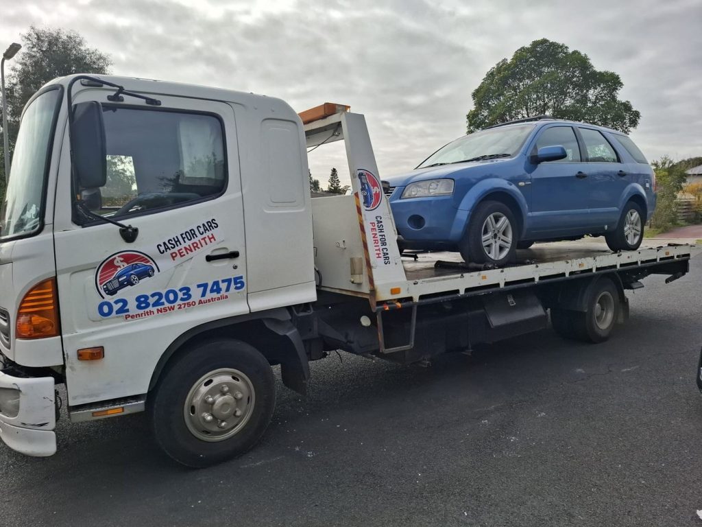 Blue Ford Territory SUV on the Cash For Cars Penrith tilt-tray truck