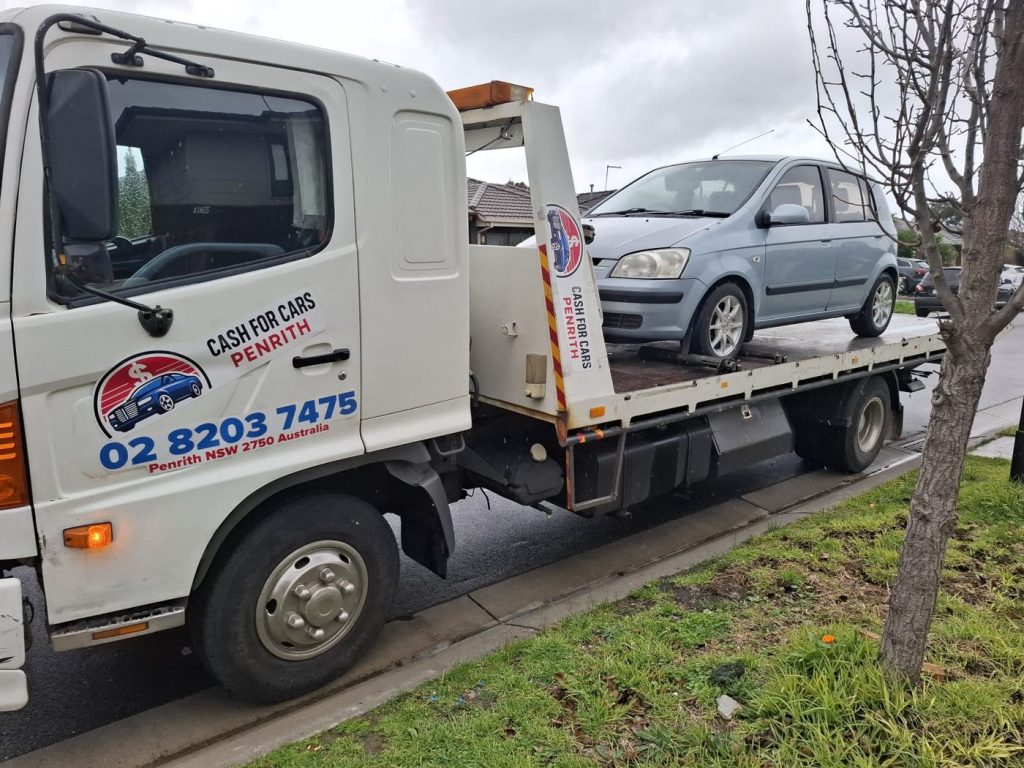 Light blue Hyundai Getz hatchback on the Cash For Cars Penrith tilt-tray truck