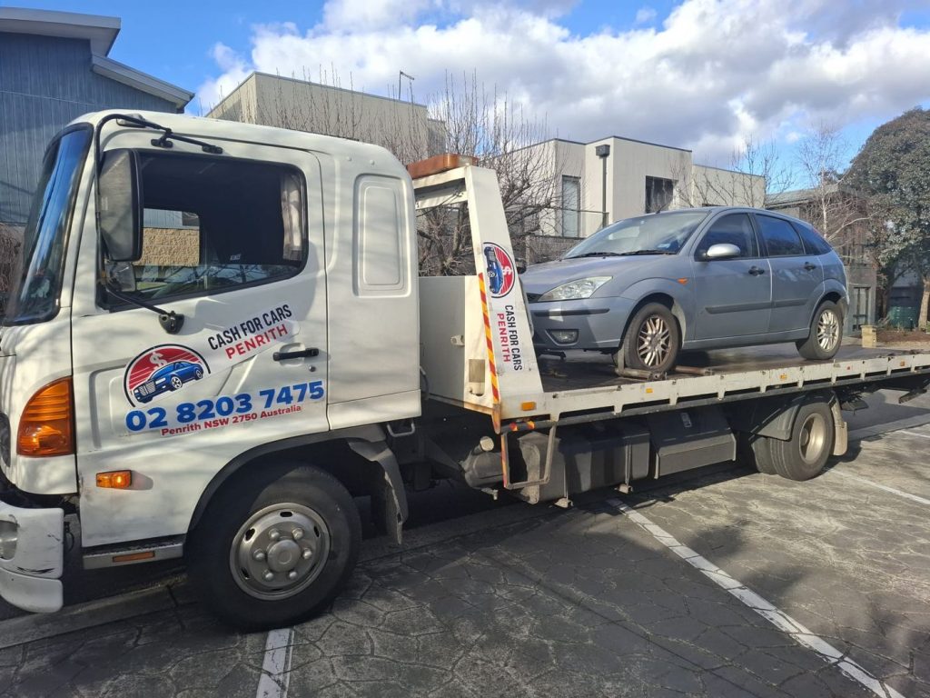 Older grey Ford Focus hatchback on the Cash For Cars Penrith tilt-tray truck