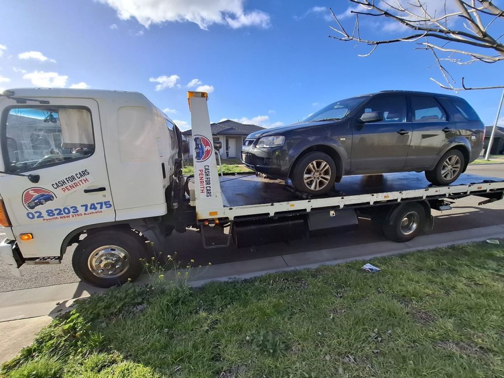Dark grey Ford Territory SUV loaded on the Cash For Cars Penrith tilt-tray truck