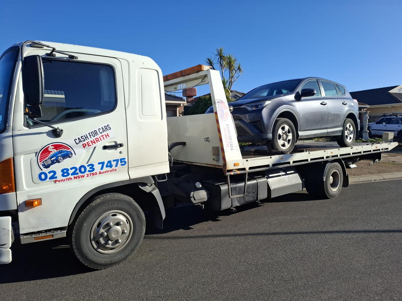 Grey Toyota RAV4 SUV loaded on the Cash For Cars Penrith tilt-tray truck