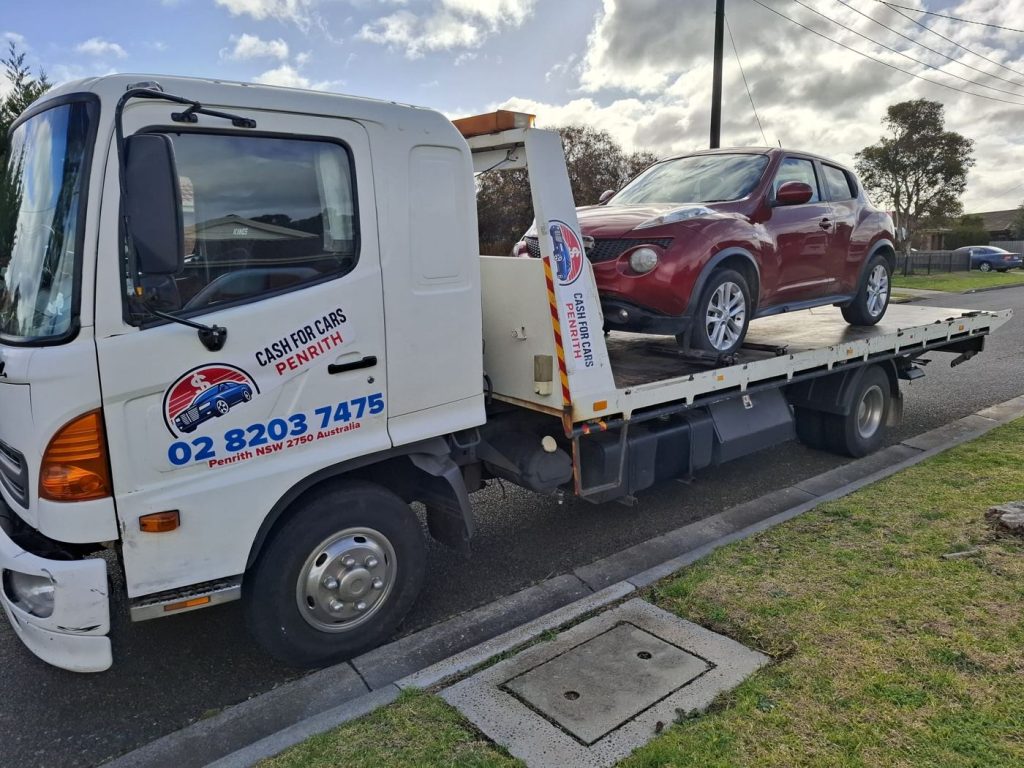 Red Nissan Juke on the Cash For Cars Penrith tilt-tray truck