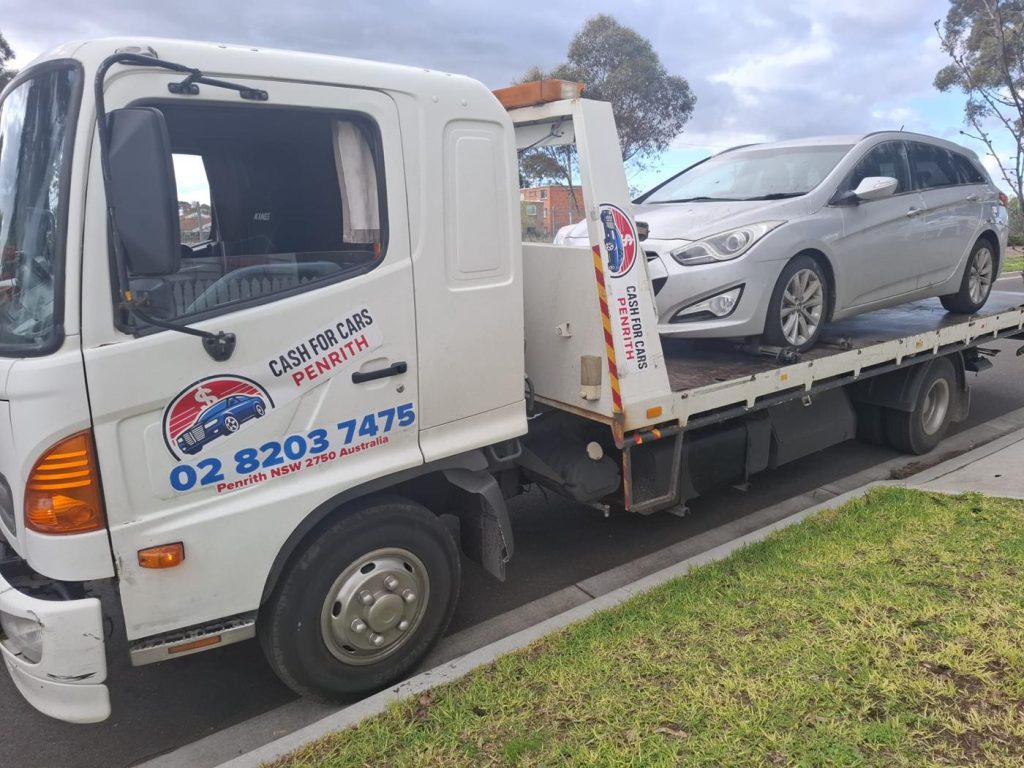 Silver Hyundai i40 wagon on the Cash For Cars Penrith tilt-tray truck
