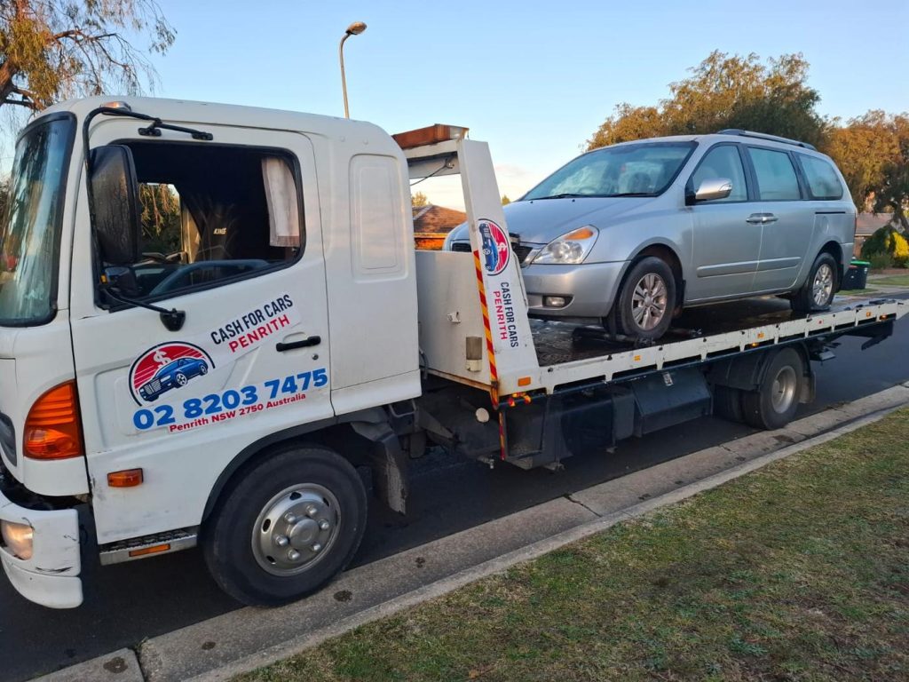 Silver Kia Carnival people mover on the Cash For Cars Penrith tilt-tray truck