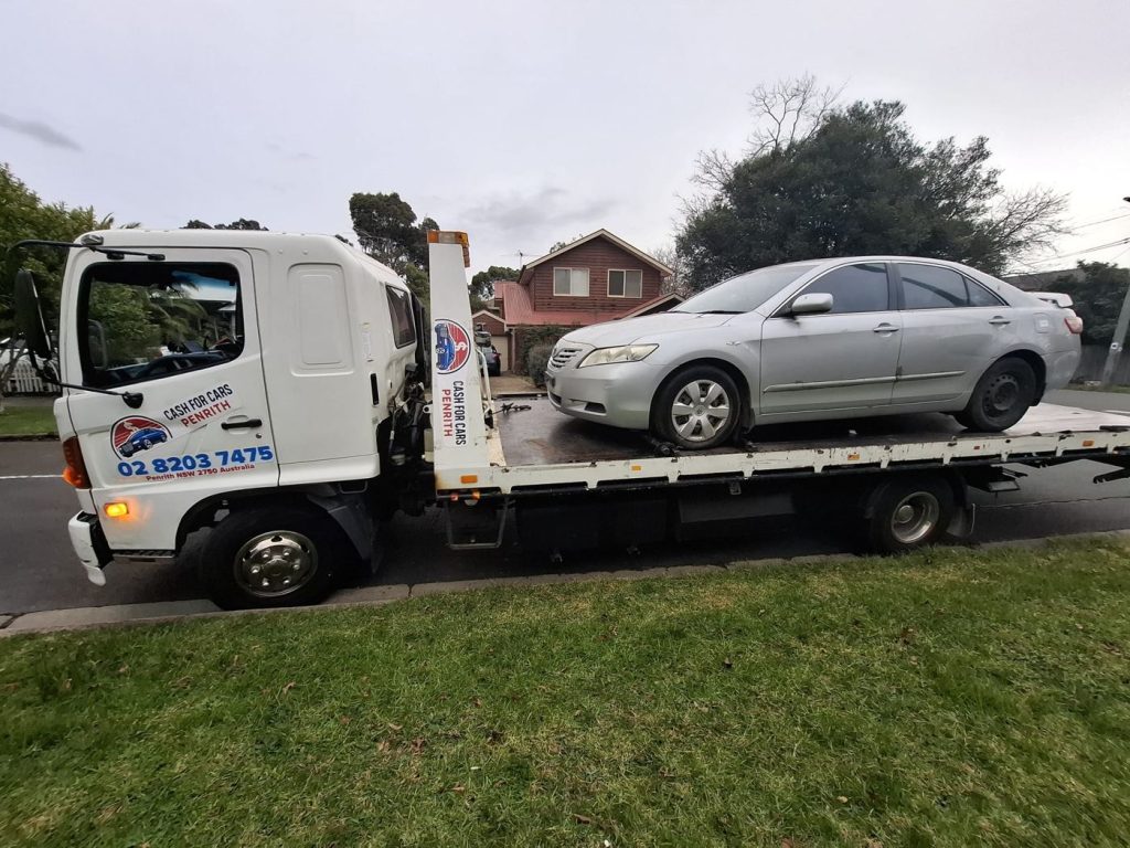 Silver Toyota Camry sedan on the Cash For Cars Penrith tilt-tray truck