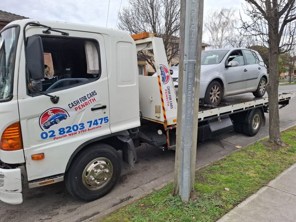 Silver Volkswagen Golf hatchback on the Cash For Cars Penrith tilt-tray truck