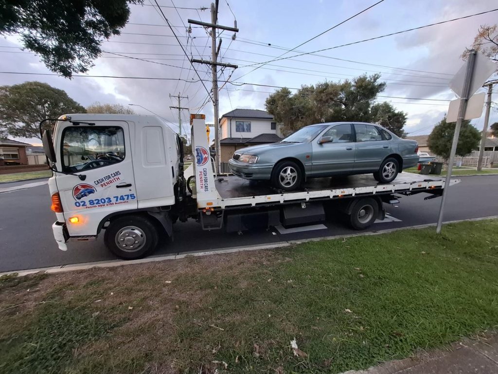 Grey-green Toyota Avalon sedan on the Cash For Cars Penrith tilt-tray truck