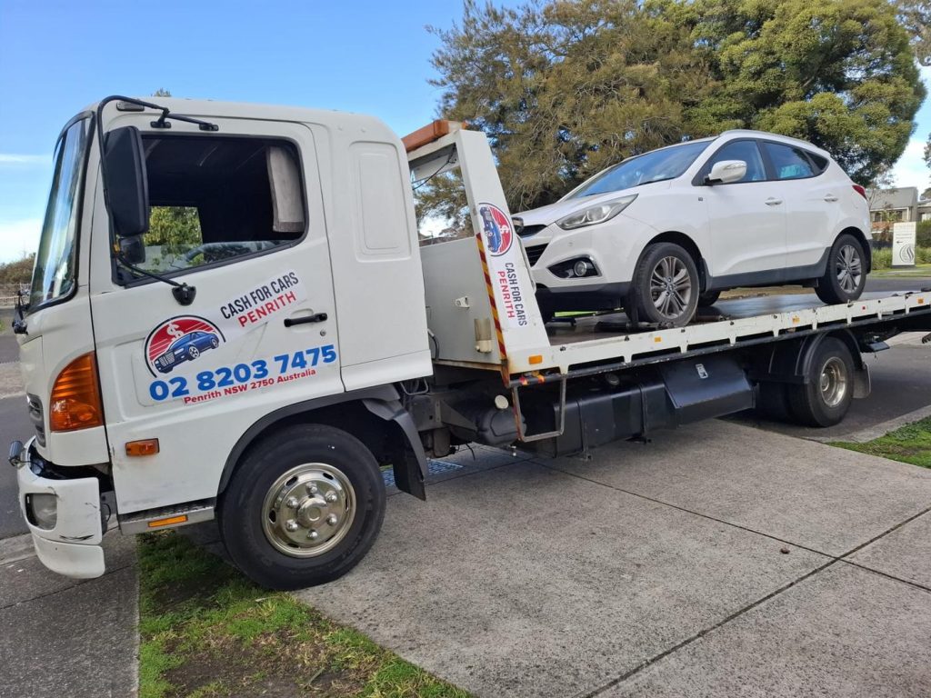 White Hyundai ix35 SUV on the Cash For Cars Penrith tilt-tray truck