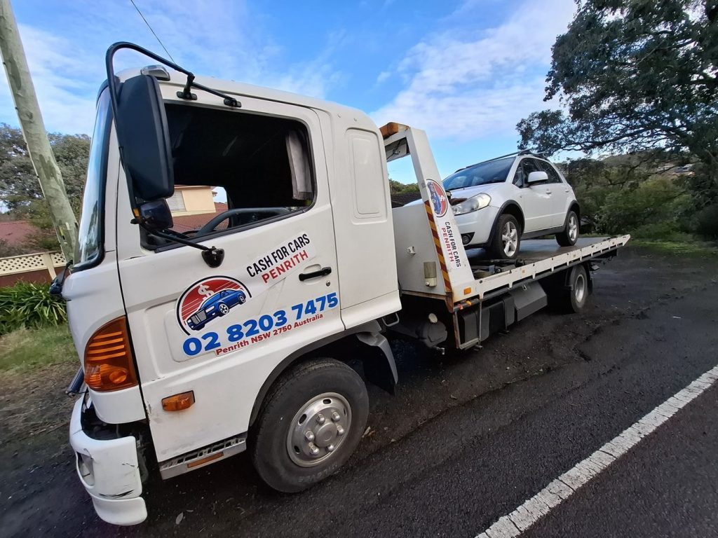 White Suzuki SX4 on the Cash For Cars Penrith tilt-tray truck